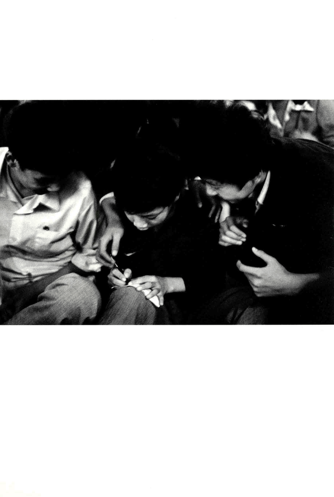 三个年轻人围坐书写